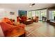Spacious living room featuring comfortable seating, a stone fireplace, and access to a serene outdoor patio at 7955 Midnight Ln, Wake Forest, NC 27587