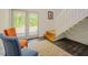 Inviting living room with access to the outside and stairs to the upper level with stylish furniture and wood flooring at 7955 Midnight Ln, Wake Forest, NC 27587