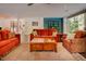 Open-concept living room featuring a fireplace, hardwood floors, and large windows with views of outdoor living space at 7955 Midnight Ln, Wake Forest, NC 27587
