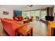 Bright living room boasts hardwood floors and a stone fireplace with sliding glass doors to the outdoor living space at 7955 Midnight Ln, Wake Forest, NC 27587