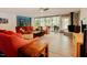 Bright living room with a cozy fireplace, hardwood floors, and large windows that offer views of the outdoors at 7955 Midnight Ln, Wake Forest, NC 27587