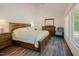 Tranquil main bedroom featuring natural light, wood floors, and classic wood furniture at 7955 Midnight Ln, Wake Forest, NC 27587