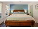 Bedroom featuring dark hardwood floors, a ceiling fan, and a beautiful accent wall at 7955 Midnight Ln, Wake Forest, NC 27587