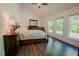 Bright and spacious main bedroom with wood floors, large windows, and a calming atmosphere at 7955 Midnight Ln, Wake Forest, NC 27587