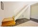 Bright staircase with light wood treads, white risers and railings, and dark hardwood floors at 7955 Midnight Ln, Wake Forest, NC 27587