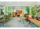 Open sunroom featuring a dining table, comfortable seating, and sliding glass doors that lead to a deck at 7955 Midnight Ln, Wake Forest, NC 27587