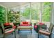 Relaxing sunroom with plenty of natural light, comfortable seating, and a view of the expansive yard at 7955 Midnight Ln, Wake Forest, NC 27587