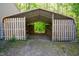 Open storage area with sturdy wood fencing and metal awning to keep logs and firewood dry and secure at 7955 Midnight Ln, Wake Forest, NC 27587