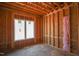 Framed bedroom with large window and insulation, under construction at 7961 Wexford Waters Ln, Wake Forest, NC 27587