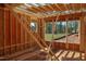 The wood frame shows the construction of new rooms and large window placements at 7961 Wexford Waters Ln, Wake Forest, NC 27587