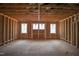 Unfinished living room featuring exposed wooden framing and several windows at 7961 Wexford Waters Ln, Wake Forest, NC 27587