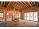 Unfinished living area featuring fireplace and sliding glass doors at 7961 Wexford Waters Ln, Wake Forest, NC 27587