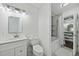 Bright bathroom with a walk-in closet, shower and tub combination, white vanity, and neutral finishes at 8 Bluebell Ct, Durham, NC 27713