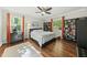 Spacious bedroom with hardwood floors, ceiling fan and two large windows at 8 Bluebell Ct, Durham, NC 27713