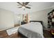Well-lit bedroom with hardwood floors, fan, modern decor and large window views at 8 Bluebell Ct, Durham, NC 27713