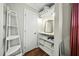 Well-lit closet with storage shelves, mirror, and hardwood floors at 8 Bluebell Ct, Durham, NC 27713
