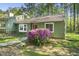 Charming home featuring a well maintained front yard, bay window, and a vibrant red front door at 8 Bluebell Ct, Durham, NC 27713