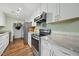 This bright kitchen features stainless steel appliances, white cabinetry, and neutral countertops at 8 Bluebell Ct, Durham, NC 27713