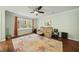 Bright living room with hardwood floors, large windows, and a ceiling fan at 8 Bluebell Ct, Durham, NC 27713