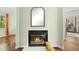 Bright living room with fireplace, wooden floors, and arch mirror at 8 Bluebell Ct, Durham, NC 27713