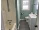 Charming bathroom featuring a tiled shower, white vanity, and plenty of natural light at 83 Brentwood Dr, Selma, NC 27576