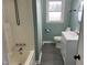Charming bathroom featuring a tiled shower, white vanity, and plenty of natural light at 83 Brentwood Dr, Selma, NC 27576
