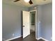 Bedroom features blue walls, gray flooring, and a doorway leading into another area at 83 Brentwood Dr, Selma, NC 27576