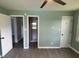 This is a spacious bedroom featuring modern gray floors and three entryways, providing easy access to other areas at 83 Brentwood Dr, Selma, NC 27576