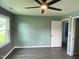 This bedroom has calming blue-green walls, wood floors, and a modern ceiling fan at 83 Brentwood Dr, Selma, NC 27576