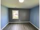 Bedroom includes two-tone blue and grey walls, along with a window offering natural light and a view at 83 Brentwood Dr, Selma, NC 27576