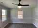 Bright bedroom with two windows, wood plank flooring and a modern ceiling fan at 83 Brentwood Dr, Selma, NC 27576