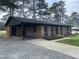 Charming brick home with a covered carport, well-maintained lawn, and mature trees at 83 Brentwood Dr, Selma, NC 27576