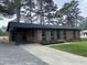 Brick house with well-maintained lawn, featuring a driveway and lush green surroundings at 83 Brentwood Dr, Selma, NC 27576