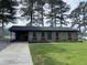 Charming brick house with well-maintained lawn, featuring a driveway and lush green surroundings at 83 Brentwood Dr, Selma, NC 27576