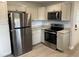 Well-lit kitchen featuring stainless steel appliances, granite countertops and sleek white cabinets at 83 Brentwood Dr, Selma, NC 27576