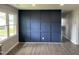 Spacious living room boasts wood plank flooring and a stylish dark blue accent wall at 83 Brentwood Dr, Selma, NC 27576