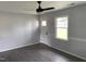 The airy living room features stylish gray walls, wood floors, and a modern ceiling fan at 83 Brentwood Dr, Selma, NC 27576