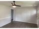 Bright living room featuring modern ceiling fan, wood plank flooring, fresh paint and large windows at 83 Brentwood Dr, Selma, NC 27576
