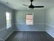Open-concept living room features wood plank flooring, modern ceiling fan and freshly painted walls at 83 Brentwood Dr, Selma, NC 27576
