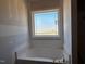 Bathroom with tub beneath a window at 871 Olive Branch Dr, Smithfield, NC 27577