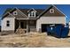 New construction home with a mix of lap siding and partial brick facade, and an attached two-car garage at 871 Olive Branch Dr, Smithfield, NC 27577