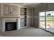 Living room shows fireplace, built-in shelves, and sliding glass doors leading to the backyard at 871 Olive Branch Dr, Smithfield, NC 27577