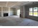 Spacious living room featuring an elegant fireplace and a sliding glass door leading to the outside at 871 Olive Branch Dr, Smithfield, NC 27577