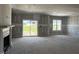 Spacious living room features a fireplace, large windows, and sliding glass door to backyard at 871 Olive Branch Dr, Smithfield, NC 27577