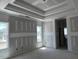 Main bedroom features a tray ceiling, large windows, and access to an ensuite bathroom at 871 Olive Branch Dr, Smithfield, NC 27577
