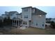 A two-story home with a screened porch, a backyard, and many large windows for natural light at 901 Hollymont Dr, Holly Springs, NC 27540