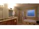 This bathroom features dual sinks, a tiled shower, and a separate soaking tub at 901 Hollymont Dr, Holly Springs, NC 27540