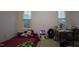 Cozy bedroom with pink walls, and two windows with views at 901 Hollymont Dr, Holly Springs, NC 27540