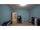 This bedroom features calming blue walls, neutral carpet, and ample space for a desk and storage at 901 Hollymont Dr, Holly Springs, NC 27540