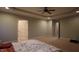 This bedroom has recessed lighting, neutral carpet, a ceiling fan, and access to an attached bathroom at 901 Hollymont Dr, Holly Springs, NC 27540